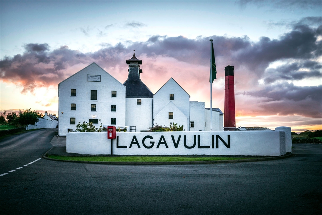 Lagavulin Distillery on Islay’s rugged coastline at sunset